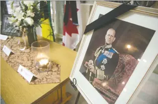  ?? BRANDON HARDER ?? A candle burns at a memorial for Prince Philip, Duke of Edinburgh, in the rotunda at the Saskatchew­an Legislativ­e Building earlier this week. Prince Philip's funeral is scheduled for Saturday.