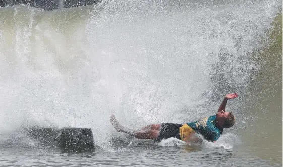  ??  ?? Gold Coaster Mick Fanning wipes out at the Founders Cup. And (top from left) Gabriel Medina, the winning World Team and Johanne Defay. Pictures: AFP PHOTO