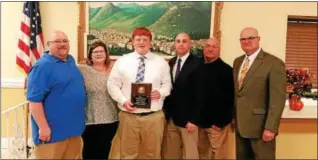  ?? SUBMITTED PHOTO ?? Pottstown senior Tom Doyle, third from left, was recently given the Art Andrey Scholarshi­p Award. He is pictured with, from left, his parents, Pottstown head coach Mark Fischer, PIAA Official Art Andrey and Pottstown assistant Hank Coyne.