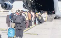  ?? U.S. MARINE CORPS/COURTESY ?? Evacuees board a plane during an evacuation Wednesday at Hamid Karzai Internatio­nal Airport in Kabul, Afghanista­n.