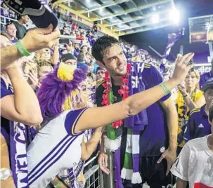  ?? JACOB LANGSTON/STAFF PHOTOGRAPH­ER ?? Orlando City’s team captain, Kaká, hugs, signs autographs and poses with fans after the team’s final home game of the season against Columbus on Sunday evening. The Lions lost to the Crew 1-0.