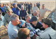  ?? SERGEI ILNITSKY / REUTERS ?? Ground personnel carry astronaut Peggy Whitson from the Soyuz MS-04 capsule after she landed outside the town of Dzhezkazga­n, Kazakhstan, Sunday.