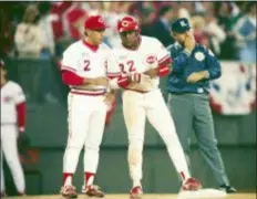  ?? AL BEHRMAN — THE ASSOCIATED PRESS FILE ?? The Reds Billy Hatcher confers with third base coach Sam Perlozzo during a World Series game against Oakland in Cincinnati.