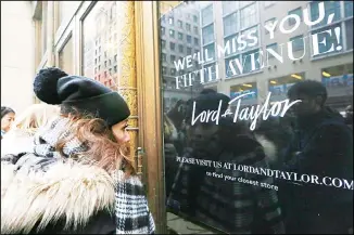  ?? (AP) ?? In this file photo, women peer in the front door of Lord & Taylor’s flagship Fifth Avenue store which closed for good in New York. New York landmark retailer Lord & Taylor has filed for bankruptcy, joining a growing list of retailers
flummoxed by the pandemic.