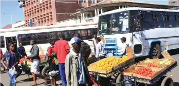  ?? - Picture by Munyaradzi Chamalimba ?? Vendors obstruct buses and other motorists as they set their pushcarts with fruits in the middle of the road a stone throw away from Harare Central Police Station.