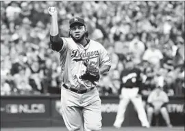  ?? Wally Skalij Los Angeles Times ?? PEDRO BAEZ of the Dodgers records an out at first base after fielding a grounder in the seventh inning Saturday. The reliever earned his first postseason win.