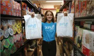  ??  ?? goPuff will begin serving the West Chester area this week. This photo shows a goPuff employee who has packed up an order in the warehouse, preparing it for delivery. goPuff stocks more than 3,000 items for delivery, from snacks, to school supplies, pet food and household items.