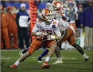  ?? ASSOCIATED PRESS FILE ?? Clemson’s Trevor Lawrence scrambles against Pittsburgh in the second half of the ACC championsh­ip in Charlotte, N.C.