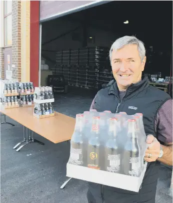  ??  ?? Beer ordered by phone is collected from the rear of the premises with staff watching at a socially-acceptable distance.