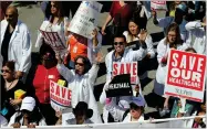  ?? AP FILE PHOTO BY REED SAXON ?? In this 2017, file photo, health care profession­als join hundreds of people marching through downtown Los Angeles protesting President Donald Trump’s plan to dismantle the Affordable Care Act.