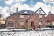  ?? CONTRIBUTE­D PHOTOS ?? The brick, Tudor-style home has about 2,660 square feet of living space with four bedrooms and a partially finished basement. Connected to the living room is a sun/ sitting room with built-in bookcases.