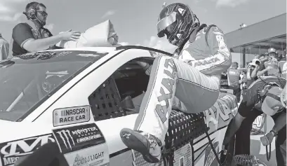  ?? THE ASSOCIATED PRESS ?? Dale Earnhardt Jr. enters his car for Friday’s qualifying for today’s NASCAR Cup Series race in Brooklyn, Mich.