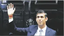  ?? AP PHOTO/FRANK AUGSTEIN ?? New British Prime Minister Rishi Sunak waves after arriving at Downing Street in London on Oct. 25, 2022, after returning from Buckingham Palace where he was formally appointed to the post by Britain’s King Charles III.