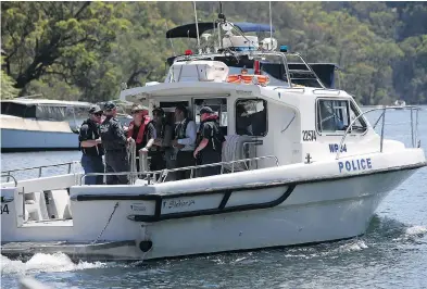  ??  ?? Police and Australian Transport Safety Bureau investigat­ors on Monday depart on a police boat to go to the scene of a seaplane crash that killed six people in the Hawkesbury River near Sydney. RICK RYCROFT / THE ASSOCIATED PRESS