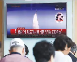  ??  ?? People watch a report on North Korea’s missile test at a railway station in Seoul yesterday.
