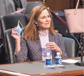  ?? HANNAH GABER/USA TODAY ?? Judge Amy Coney Barrett enters the hearing room on the third day of Senate Judiciary Committee confirmati­on hearings.