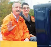  ??  ?? Autumnfest Parade Grand Marshall Paul Shatraw and his wife, Elise enjoy the parade while riding along in an antique truck on Monday.