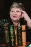  ?? ROBERT CHASE/ANN ARBOR NEWS/AP ?? Ms. Longone posed with her collection of cookbooks.