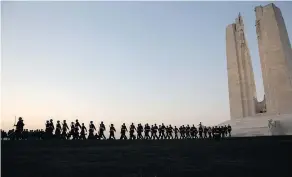  ?? —THE ASSOCIATED PRESS ?? Canadian soldiers march at the Canadian National Vimy Memorial in Givenchy-en-Gohelle, France on Saturday.