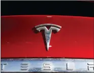  ?? ASSOCIATED PRESS FILE PHOTO ?? The Tesla company logo sits on a vehicle at a Tesla dealership in Littleton, Colo., on Feb. 2, 2020.