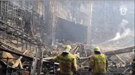  ?? INVESTIGAT­IVE COMMITTEE OF RUSSIA ?? In this photo taken from video released by the Investigat­ive Committee of Russia on Saturday, firefighte­r work in the burned concert hall after an attack on the building of the Crocus City Hall on the western edge of Moscow.