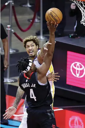  ?? Carmen Mandato/Pool Photo via AP ?? ■ Golden State Warriors' Kelly Oubre Jr., rear, defends against a shot from Houston Rockets' Danuel House Jr. during the first quarter of an NBA basketball game Wednesday in Houston.