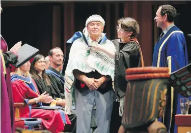  ??  ?? John Edward Elliott Sr., an Elder of the Tsartlip Nation, receives an honorary doctor of education at the University of Victoria in 2019. Retired UVic faculty member Ian Cameron argues systemic racism against Indigenous people is not embedded in the B.C. school system.