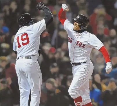  ?? STAFF PHOTOS BY CHRISTOPHE­R EVANS ?? HAVING A BASH: Mookie Betts gets congratula­tions from Jackie Bradley Jr. (19) after belting a grand slam in the Red Sox’ 14-1 victory against the Yankees last night. Sox starter Chris Sale (right) was solid again, allowing one run over six innings.