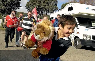  ?? PHOTO: ROSS GIBLIN/FAIRFAX NZ ?? Above, Chandler Hayward, then 5, runs off with the cherished mascot of a group of Lions rugby supporters at the Hutt Park Motor Camp where he stayed during the 2005 tour.