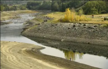  ?? / The Denver Post ?? A woman fly fishes in the heavily receding waters of Green Mountain Reservoir in August 2021 in Heeney.