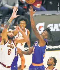  ??  ?? UP & OVER: Reggie Bullock, who finished with 17 points and seven rebounds, shoots over JaVale McGee (left) during the third quarter of the Knicks’ 95-86 win over the Cavs.