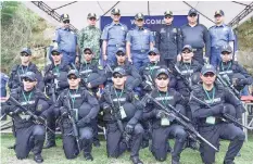  ??  ?? Members of PRO-7's Special Weapons and Tactics (SWAT) pose for a photo opportunit­y with high-ranking police officials during the opening of the 2nd National SWAT Challenge last week. PHOTO COURTESY OF PRO-7