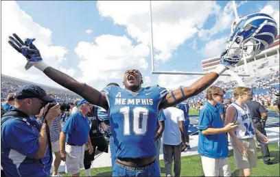  ?? [MARK HUMPHREY/THE ASSOCIATED PRESS] ?? Memphis wide receiver Damonte Coxie celebrates Saturday as he leaves the field after Memphis beat UCLA, 48-45, in Memphis, Tenn.