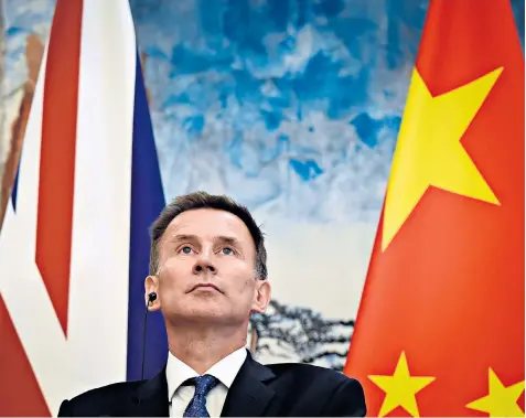  ??  ?? Jeremy Hunt at a joint press conference in Beijing. During his diplomatic mission to China, he mistakenly described his Chinese wife Lucia, below, as Japanese