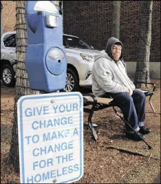  ??  ?? Joe Drury, who said he is homeless, sits near a parkingsty­le meter in Annapolis, Md., used to collect loose change.