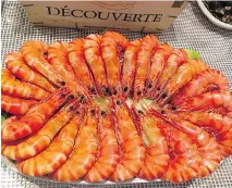  ??  ?? A platter of fresh prawns at Os Lusiadas, an unpretenti­ous restaurant in the port area of Matosinhos, in Porto, that specialize­s in fresh seafood.
