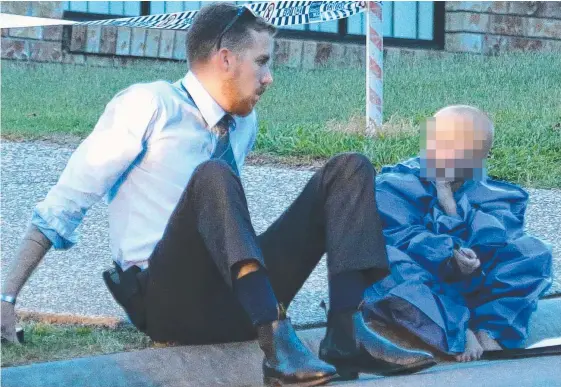  ?? Picture: GLENN HAMPSON ?? A police officer sits with the son of Renee Carter, who was killed by Christophe­r Carter.