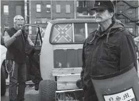  ??  ?? A National Socialist Movement member holds a shield during a white supremacis­t rally AP