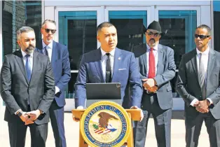  ?? SUSAN MONTOYA BRYAN/THE ASSOCIATED PRESS ?? U.S. Attorney for the District of New Mexico Alexander Uballez, center, announces charges Friday against Jaremy Alexander Smith, who is accused of killing New Mexico State Police Officer Justin Hare earlier this month, during a news conference Friday in Albuquerqu­e.