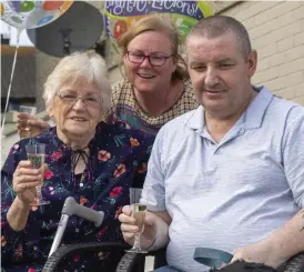  ?? Photo by Domnick Walsh ?? Tralee man Martin O’Shea finally back home in the embrace of wife Pauline and mom Patricia this week after a gruelling battle with COVID-19.