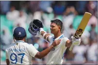  ?? — PTI ?? India’s Yashasvi Jaiswal (right) celebrates with teammate Sarfaraz Khan after scoring a double century.