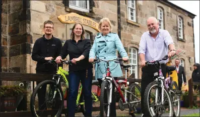  ??  ?? Roseanna Cunningham, MSP, third from left, at Lambhill Stables with bike mechanic Hugh MacGregor, Amelia Irvine, project and developmen­t manager, and general manager Stephen Irvine Pictures: Colin Mearns