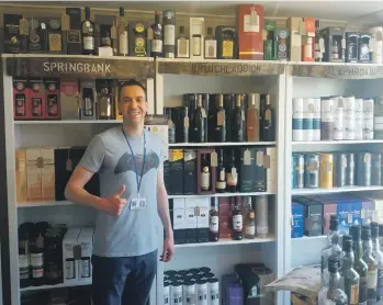  ??  ?? Alastair Redman was happy to find Islay and Jura whiskies in Tarbert’s Whisky West Coast shop.