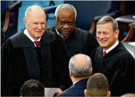  ?? DREW ANGERER / GETTY IMAGES 2017 ?? Supreme Court Justice Anthony Kennedy (left) — standing with Justice Clarence Thomas (center) and Chief Justice John Roberts — will retire July 31. Roberts will fill Kennedy’s role as the “median justice” on the court.