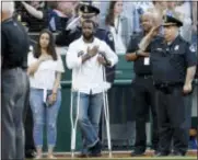  ?? ALEX BRANDON — THE ASSOCIATED PRESS ?? Injured Capitol Hill Police officer David Bailey, center, holds his hand over his heart during the National Anthem with U.S. Capitol Police Chief Matthew Verderosa, far right, before the Congressio­nal baseball game, Thursday in Washington. The annual...