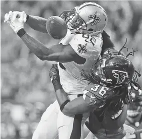  ?? THE ASSOCIATED PRESS ?? New Orleans Saints tight end Benjamin Watson misses the catch against Atlanta Falcons strong safety Kemal Ishmael during the NFC South rivals’ game in Atlanta this past January.