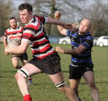  ??  ?? Jim White of Enniscorth­y shaking off the close attention of Wexford’s Kevin Roche.