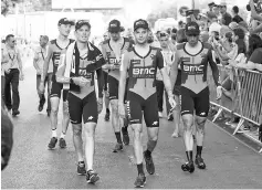  ??  ?? The BMC Racing Australian Team walk to the podium after winning the first stage of the 72nd edition of “La Vuelta”Tour of Spain cycling race, a 13.7 km team trial time in Nimes on August 19, 2017. - AFP photo