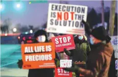  ?? — Reuters ?? Activists in opposition to the death penalty gather to protest the execution of Lisa Montgomery, the first woman put to death by the federal government in nearly 70 years, at the United States Penitentia­ry in Indiana.