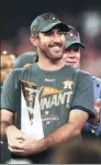  ?? TROY TAORMINA / USA TODAY SPORTS ?? Houston Astros starting pitcher Justin Verlander poses with the MVP trophy after the Astros beat the New York Yankees 4-0 on Saturday to win the AL Championsh­ip Series.